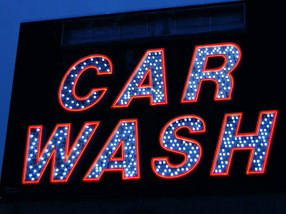 Illuminated Car Wash sign glowing at night