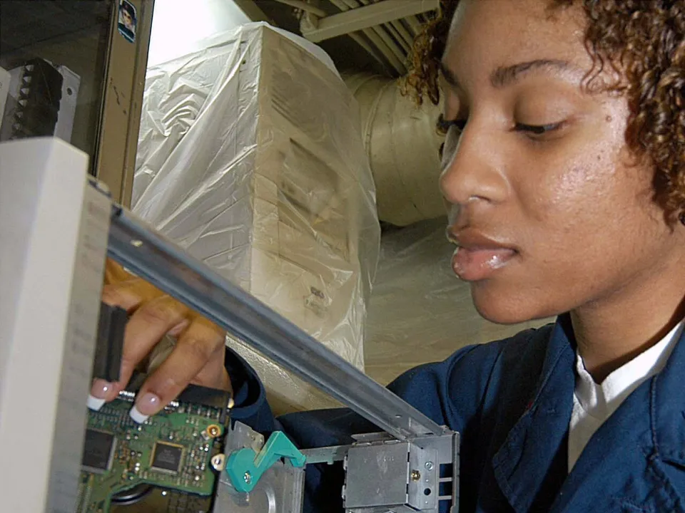 Technician working inside a computer