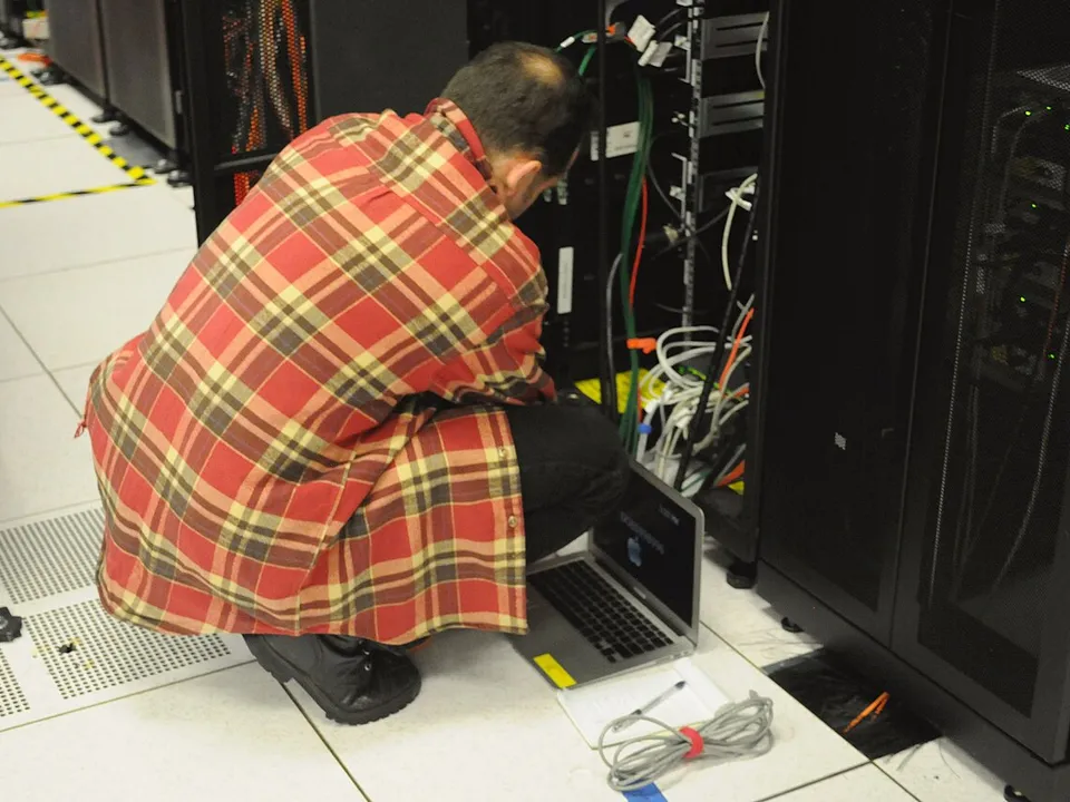 Technician working on a web server rack